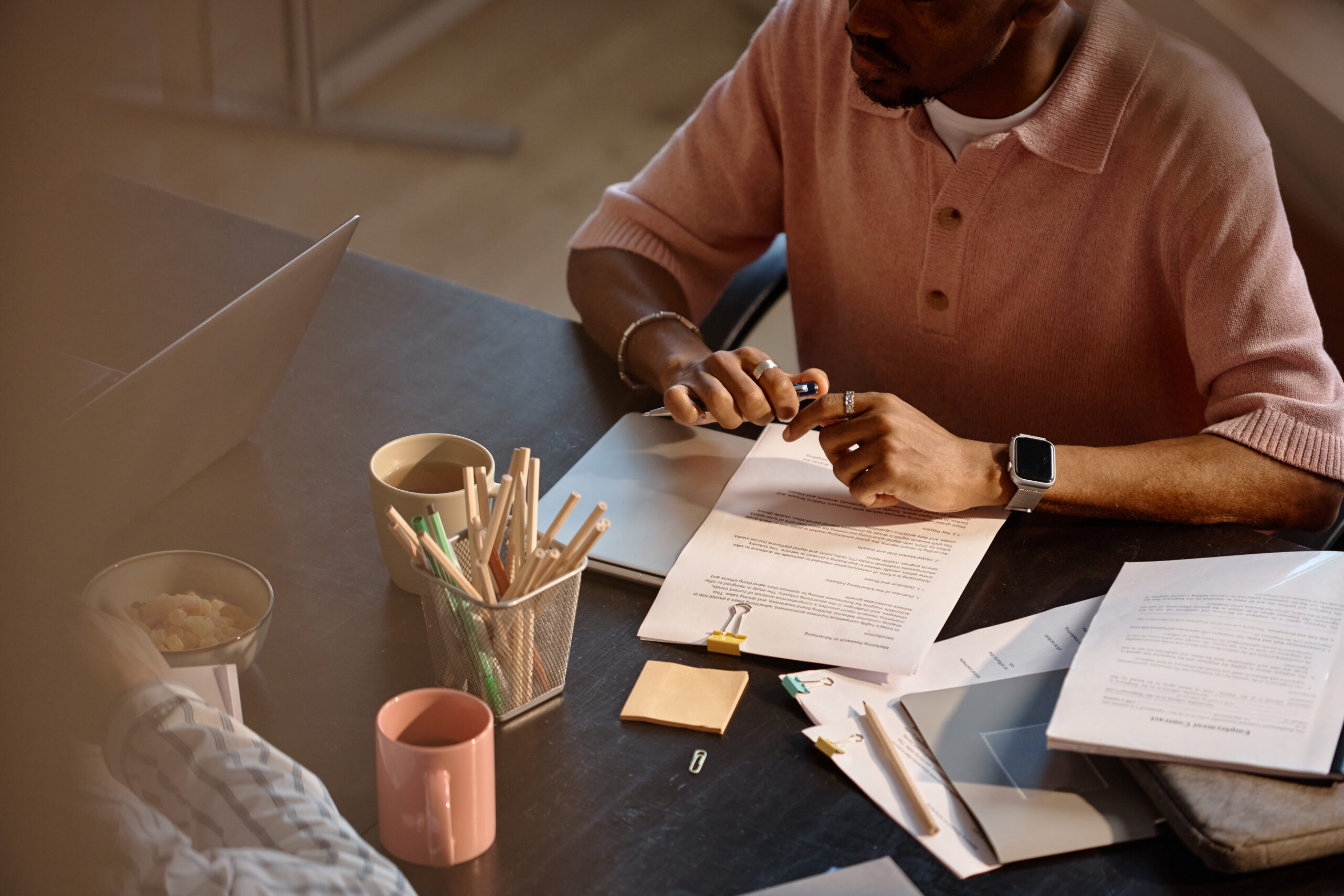 Black Man Reviewing Documents during Business Meeting at Office
